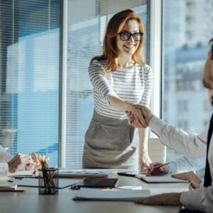 A professional congratulating another professional symbolizing a company's successful ISO Certification